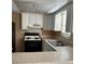 Functional kitchen with white cabinetry, tile countertops, and essential appliances at 3040 Pinder Ct, Orlando, FL 32811