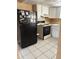 Practical kitchen space includes a black refrigerator, range, and tile flooring at 3040 Pinder Ct, Orlando, FL 32811