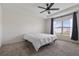 Bright bedroom features a ceiling fan, tray ceiling, and a large window at 3222 Sweet Acres Pl, St Cloud, FL 34772
