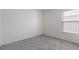 Bedroom with neutral carpet, a window, and white walls for personalization at 3222 Sweet Acres Pl, St Cloud, FL 34772