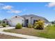 Charming single-story home featuring an attached two-car garage and a well-maintained front yard with tropical landscaping at 3222 Sweet Acres Pl, St Cloud, FL 34772