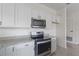Kitchen features stainless appliances, granite countertops, and white cabinetry at 3222 Sweet Acres Pl, St Cloud, FL 34772