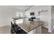 Well-equipped kitchen boasting granite counters, stainless steel appliances, white cabinetry and an island with barstool seating at 3222 Sweet Acres Pl, St Cloud, FL 34772