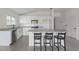 Well-equipped kitchen boasting granite counters, stainless steel appliances, white cabinetry and an island with barstool seating at 3222 Sweet Acres Pl, St Cloud, FL 34772