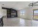 Contemporary living area featuring a built-in fireplace, large window with natural light, and tile flooring at 3222 Sweet Acres Pl, St Cloud, FL 34772