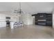 Open-concept living space with a modern fireplace, tile flooring, and kitchen island with barstool seating at 3222 Sweet Acres Pl, St Cloud, FL 34772