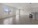 Light-filled living area with tile floors, offering an open layout with the kitchen island and access to the outdoors at 3222 Sweet Acres Pl, St Cloud, FL 34772