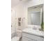 Clean bathroom featuring a toilet, vanity with sink, mirror, and tiled shower with a towel rack at 3238 Viceroy Ct, Poinciana, FL 34759
