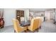 Well-lit dining room showcasing stylish chairs and an open layout with a view into the modern kitchen at 3238 Viceroy Ct, Poinciana, FL 34759