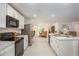 Modern kitchen with white cabinetry, stainless steel appliances, and an open design that flows into the living spaces at 3238 Viceroy Ct, Poinciana, FL 34759
