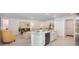 Modern kitchen with a central island, stainless steel appliances, and open layout connecting to the living room at 3238 Viceroy Ct, Poinciana, FL 34759