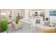 Bright, open-concept living room with contemporary furnishings, connecting seamlessly to the kitchen at 3238 Viceroy Ct, Poinciana, FL 34759