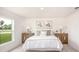 Bright main bedroom with neutral décor, decorative lamps, and a large window offering a pleasant outdoor view at 3238 Viceroy Ct, Poinciana, FL 34759