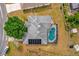 Aerial view showcasing the house's solar panels, pool, backyard and location in a suburban neighborhood at 329 Alegriano Ct, Kissimmee, FL 34758