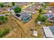 Aerial view of a home showcasing the pool with enclosure, landscaping, and solar panels on the roof at 329 Alegriano Ct, Kissimmee, FL 34758