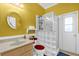 Bright bathroom with a glass block shower and a round mirror over a modern sink at 329 Alegriano Ct, Kissimmee, FL 34758