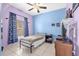 Cozy bedroom featuring a ceiling fan, neutral paint, and a window with dark curtains at 329 Alegriano Ct, Kissimmee, FL 34758