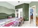 Comfortable bedroom featuring unique accent wall and tile flooring at 329 Alegriano Ct, Kissimmee, FL 34758