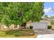 Residential house showing lawn, mature trees, and a two-car garage at 329 Alegriano Ct, Kissimmee, FL 34758