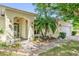 Charming home with a colorful landscaped front yard and inviting covered entryway at 329 Alegriano Ct, Kissimmee, FL 34758