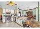 Kitchen with stainless steel appliances, white cabinetry, and breakfast bar overlooking the dining area at 329 Alegriano Ct, Kissimmee, FL 34758