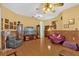 Living room featuring tile floors, ceiling fan, television, and comfortable seating at 329 Alegriano Ct, Kissimmee, FL 34758