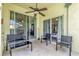 Covered patio with ceiling fan, seating, and glass sliding doors that overlook other parts of the house at 329 Alegriano Ct, Kissimmee, FL 34758