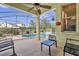 Screened-in pool patio featuring a ceiling fan, seating and a pool that is sectioned off by a fence at 329 Alegriano Ct, Kissimmee, FL 34758