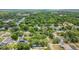 Aerial view of the neighborhood features lush tree coverage and other houses with private backyard pools at 334 Terrace Dr, Oviedo, FL 32765