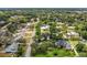 Neighborhood aerial view shows the lush tree canopy and houses with backyard pools in the community at 334 Terrace Dr, Oviedo, FL 32765