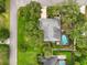 Aerial view of home featuring pool, backyard, mature landscaping, and an enclosed patio at 334 Terrace Dr, Oviedo, FL 32765