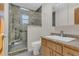 Bathroom featuring a tiled glass shower and granite vanity at 334 Terrace Dr, Oviedo, FL 32765