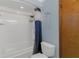 Bathroom features shower and tub combination with white tile and blue curtain at 334 Terrace Dr, Oviedo, FL 32765