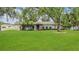 Charming single-story home with a well-maintained lawn, mature trees, and colorful landscaping at 334 Terrace Dr, Oviedo, FL 32765