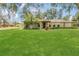 Well-manicured front yard with lush green grass and tropical plants complementing the charming single-story home at 334 Terrace Dr, Oviedo, FL 32765