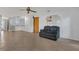 Open-concept living space with tile flooring, a wet bar, and an adjacent area for a leather sofa at 334 Terrace Dr, Oviedo, FL 32765