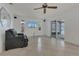 Spacious living area with tile flooring, a sleek TV, and a sliding glass door leading to the outdoors at 334 Terrace Dr, Oviedo, FL 32765