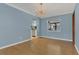 Bright living room features hardwood floors, chandelier, and view to kitchen at 334 Terrace Dr, Oviedo, FL 32765