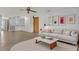 Cozy living room featuring modern decor, tile flooring, and an open layout connected to a kitchen area at 334 Terrace Dr, Oviedo, FL 32765