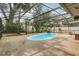 This backyard features a screened-in pool with rock waterfall, providing a private tropical oasis at 334 Terrace Dr, Oviedo, FL 32765