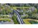 Aerial view of a pedestrian bridge overlooking ponds and landscaping, connecting the community at 338 Wooded Vine Dr, Winter Springs, FL 32708