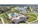Aerial of the neighborhood amenities featuring the community pool, clubhouse, playground, and neighborhood lake at 338 Wooded Vine Dr, Winter Springs, FL 32708