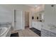Bright bathroom featuring a double vanity, bathtub, and modern fixtures, offering comfort and convenience for everyday living at 338 Wooded Vine Dr, Winter Springs, FL 32708