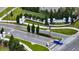 Manicured landscaping surrounds the community entrance and sign at 338 Wooded Vine Dr, Winter Springs, FL 32708