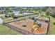 Fenced-in community playground with slides, swings, and benches at 338 Wooded Vine Dr, Winter Springs, FL 32708