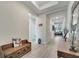 Bright foyer featuring light wood flooring, a decorative bench, and an open view into the living spaces at 338 Wooded Vine Dr, Winter Springs, FL 32708