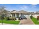 Charming single-story home featuring a brick driveway, covered porch, and well-manicured landscaping at 338 Wooded Vine Dr, Winter Springs, FL 32708