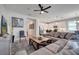 Spacious living room featuring a large sofa, modern decor, and an open layout to the kitchen at 338 Wooded Vine Dr, Winter Springs, FL 32708