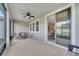 Comfortable covered patio includes ceiling fan, table, and sliding glass door leading to the inside at 338 Wooded Vine Dr, Winter Springs, FL 32708