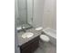 Updated bathroom features modern vanity with granite top, a sink, mirror, and a bathtub shower combination at 3408 Curlew Ave, Leesburg, FL 34748